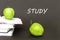Text study, two green apples, open books with concept