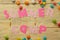 Text SUMMER CAMP of multicolored paper letters and candies on a natural wooden background. top view. flat lay