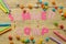 Text SUMMER CAMP of multicolored paper letters and colored crayons and candies on a natural wooden background. top view. flat lay