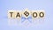 text Taboo - letters by on woodens blocks on pale lilac background, in concept of business and corporation