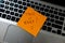 Text Take it easy on sticky note. Orange sticky note on keyboard