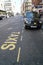 Text taxis in white letters on asphalt of street in Liverpool