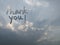 Text thank you in dramatic sky with sunlight behind the clouds