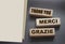 Text Thank you Merci Grazie on wooden blocks. English French Italian concept