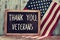 Text thank you veterans in a chalkboard and the flag of the US