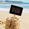 Text verao, summer in Portuguese, in a sandcastle