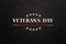 Text Veterans Day Honoring All Who Served on black textured background. American holiday typography poster.