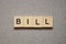 Text the word bill from brown wooden small letters