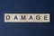 text on word damage from gray wooden letters