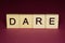 Text the word dare from gray wooden small letters