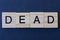 text on word dead from gray wooden letters