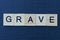 Text the word grave from gray wooden letters