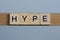 Text the word hype from brown wooden small letters