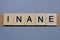 Text the word inane from brown wooden small letters