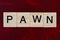 text the word pawn from gray wooden small letters