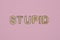 Text the word stupid from gray wooden small letters