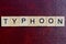 Text the word typhoon from gray wooden small letters