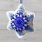 Textile christmas decoration snowflake with blue beaded embroidery  handmade close up