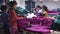 Textile Garment Factory: Many garment workers sort purple fabric pieces