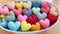 Textile multi-colored hearts in a wicker basket.