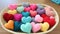 Textile multi-colored hearts in a wicker basket.