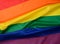 Textile rainbow flag with waves, symbol of freedom of choice of lesbians, gays, bisexuals and transgender people, LGBT culture
