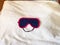 textile sleep mask on bed cover