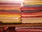 Textile stacks on a shelf in warm colors