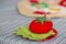 Textile toy tomato with leaves