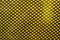 Textiles. Fabric background with mesh. The mesh piece of fabric is yellow in color. Grid