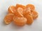 Textural orange slices of mandarin lying close up on a white background. Minimalistic background.