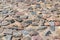 The texture of an ancient road with paving stones. Natural stone texture Close-up of an ancient paved road