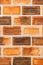 Texture and background of curly brick wall in vintage orange color, close-up. Vertical image