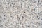 The texture background of a light granite tile interspersed with stone for design. Granite slab, marble texture