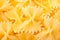 Texture background of raw italian pasta farfalle made of wheat f