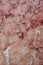 Texture background red marble with multiple strips and cracks. Vertical photo