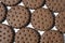 Texture background of rows of chocolate-cream cookies.