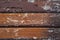 Texture background of rows of wood which coated with brown color lacquer painting, have several damage spots on the surface