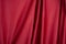 Texture, background, template. Silk fabric. Red silk drapery and upholstery fabric. Solid fabrics for backdrop, drapes, flags