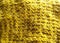 Texture and background of yellow yarn knitted fabric.