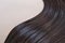 texture of beautiful glossy long hair.Curl female healthy hair. Concept hairdresser spa salon. strand of brunette silky