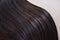 texture of beautiful glossy long hair.Curl female healthy hair. Concept hairdresser spa salon. strand of brunette silky