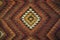 Texture of bedouin traditional wool carpet with geometric patter