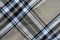 Texture of beige, black and white flannel tartan fabric