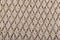 Texture of beige knitted woollen fabric