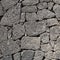 Texture of the black volcanic rock wall