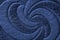 Texture of blue genuine leather close-up, with embossed twirl curve, spiral, trend pattern. Fashionable background, for