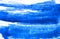 Texture of blue watercolor paint on white paper. Horizontal watercolour background.