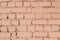 Texture of a brick wall painted with pale pink color.