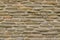 texture of bricks on the wall in the form of wild stone Background. Beige and brown tones with shadows and deep texture. Facing